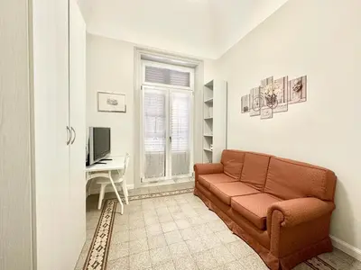 a living room with a couch and a desk at PALAZZO LA ZAGARA in Palermo