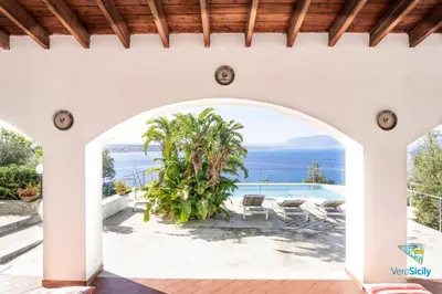 an archway in a house with a view of the ocean at Villa Giacona Venuti in Terrasini