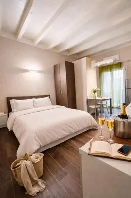 a bedroom with a bed and a table in it at Palermo Inn Studios in Palermo