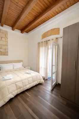 a small kitchen with a table and two chairs at Palermo Inn Studios in Palermo