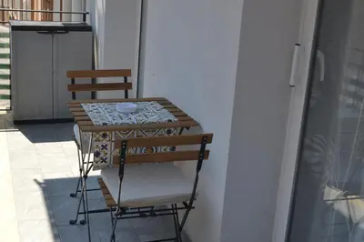 a small table and two chairs on a balcony at Casa Ventitré in Balestrate