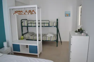 a room with two bunk beds with shoes on them at Casa Ventitré in Balestrate