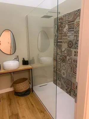 a bathroom with a glass shower and a sink at Cala nera Luxury Apartment in Palermo