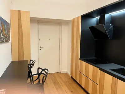 a kitchen with a black counter top and a stove at Cala nera Luxury Apartment in Palermo