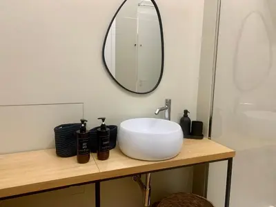 a bathroom with a white sink and a mirror at Cala nera Luxury Apartment in Palermo