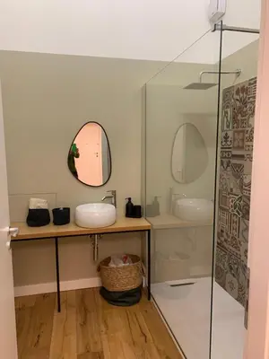 a bathroom with two sinks and a mirror at Cala nera Luxury Apartment in Palermo