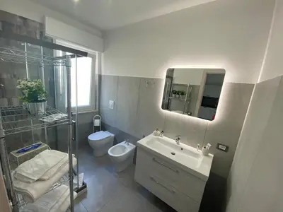 a bathroom with a sink and a toilet and a shower at City Life in Palermo