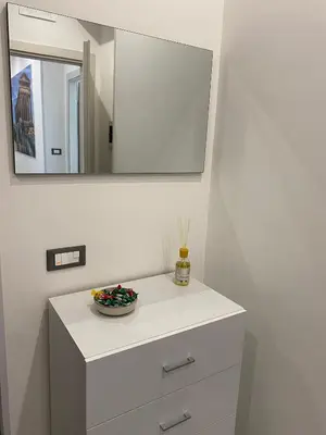 a bathroom with a white dresser with a mirror at City Life in Palermo