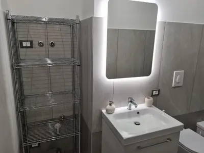 a bathroom with a sink and a mirror at City Life in Palermo