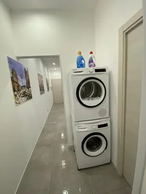 a washer and a washing machine in a hallway at City Life in Palermo