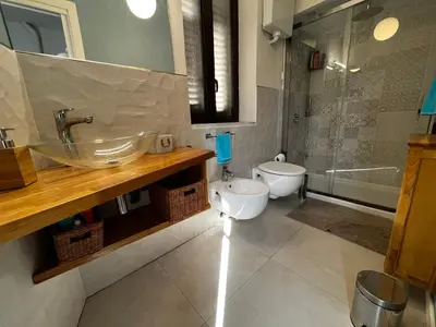 a bathroom with a sink and a toilet and a shower at A casa del Conte in Palermo