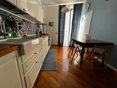 a kitchen with a sink and a table in it at A casa del Conte in Palermo