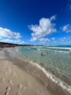 a group of people in the water at the beach at Casa Conturrana,10 metri dalla spiaggia di San Vito in San Vito lo Capo