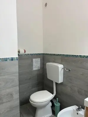 a bathroom with a white toilet and a sink at Casa Conturrana,10 metri dalla spiaggia di San Vito in San Vito lo Capo