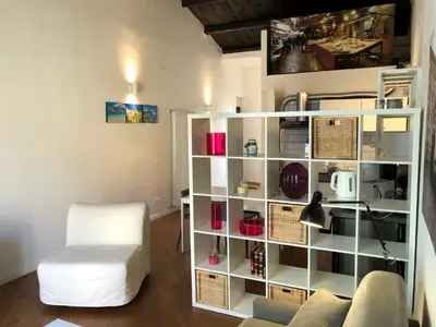a living room with a white book shelf with wicker baskets at Siandri House in Palermo