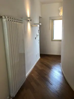 an empty room with a radiator and a window at Siandri House in Palermo