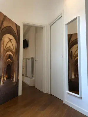 an empty hallway with a mirror and a painting on the wall at Siandri House in Palermo