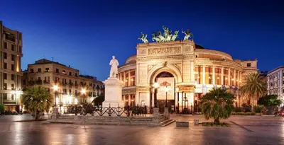 a large building with a statue in front of it at Dagnino House - Luxury apartment in the center of Palermo in Palermo