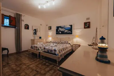 a bedroom with a bed and a table in it at Monia beach house in Santa Flavia