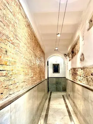 an empty hallway with a brick wall and a ceiling at Cassari 61 in Palermo