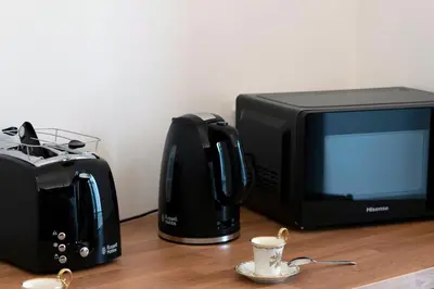 a microwave and a toaster and a coffee cup on a table at Cassari 61 in Palermo