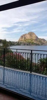 a view of a mountain in the water from a balcony at Anna&Miky beach house in Santa Flavia