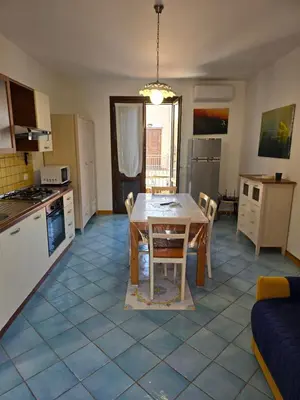 a kitchen and dining room with a table and chairs at Casa Dalila in San Vito lo Capo