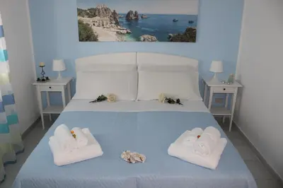 a bedroom with a bed with towels on it at Villa Nàmali just 100 meters from the sea !!! in Trappeto
