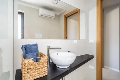 a bathroom with a sink and a mirror at Villa vista mare Piscina e SPA in Castellammare del Golfo