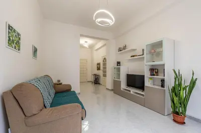 a living room with a couch and a tv at Casa Lincoln by Wonderful Italy in Palermo