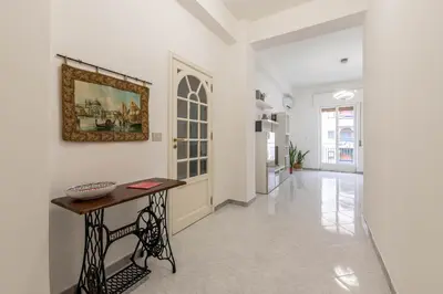 a hallway with a table and a picture on the wall at Casa Lincoln by Wonderful Italy in Palermo