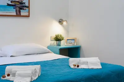 a bedroom with a bed with towels on it at Casa Serena in San Vito lo Capo