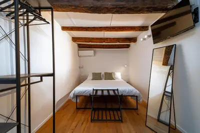 a small bedroom with a bed and a mirror at Casa Gagini in Palermo