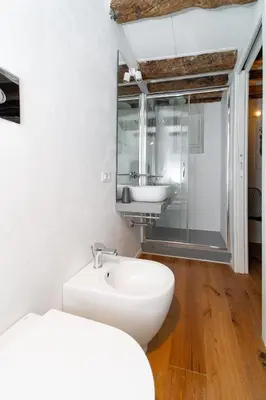 a bathroom with a sink and a toilet and a mirror at Casa Gagini in Palermo