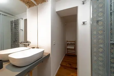 a bathroom with a white sink and a mirror at Casa Gagini in Palermo