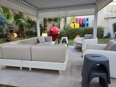 a group of white couches and chairs on a patio at Casa Slide a Palermo in Palermo