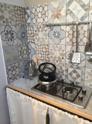 a kitchen stove with a tea pot on top of it at Casa Allegra in Palermo