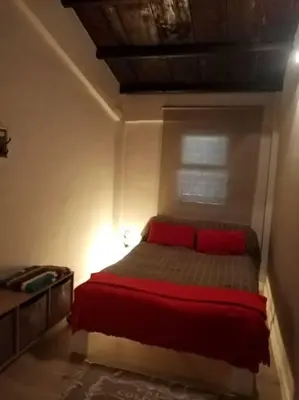 a bedroom with a bed with red pillows on it at Casa Allegra in Palermo