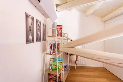 a staircase in a room with white walls and wooden floors at mialuxuryhouse in Palermo