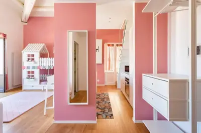 a room with pink walls and a mirror at mialuxuryhouse in Palermo