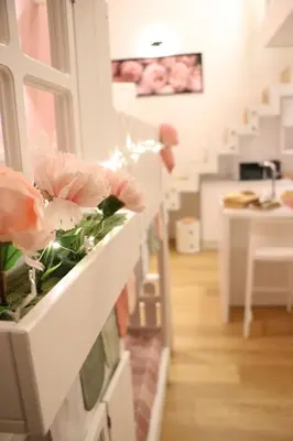 a room with a counter with pink flowers on it at mialuxuryhouse in Palermo