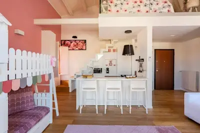 a kitchen with a table and chairs in a room at mialuxuryhouse in Palermo