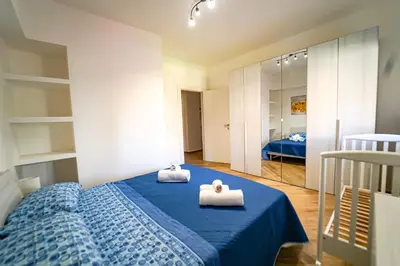 a bedroom with a blue bed with towels on it at Lovely Villa, close to the beach in Palermo