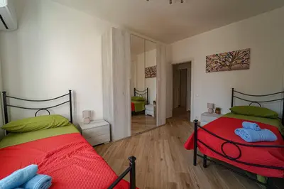 a bedroom with two beds and a mirror at Lovely Villa, close to the beach in Palermo