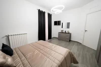 a bedroom with a bed and a dresser in it at AVA VACATION HOME in Borgetto