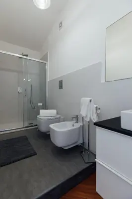 a bathroom with a toilet and a tub and a sink at Appartamento in Villa con accesso al mare, vista mozzafiato in Palermo