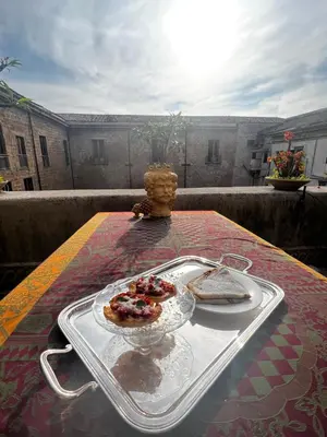 a tray with two slices of bread on a table at Donna Guia suite in Palermo