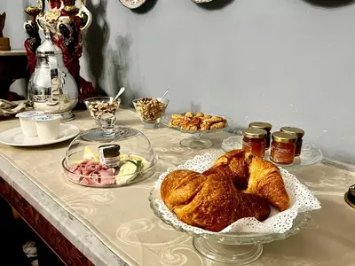 a table with pastries and other food on it at Donna Guia suite in Palermo
