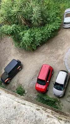 two cars are parked in a parking lot at Donna Guia suite in Palermo