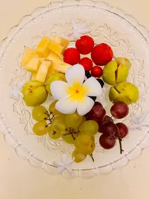 a plate of fruit on a white plate at Donna Guia suite in Palermo